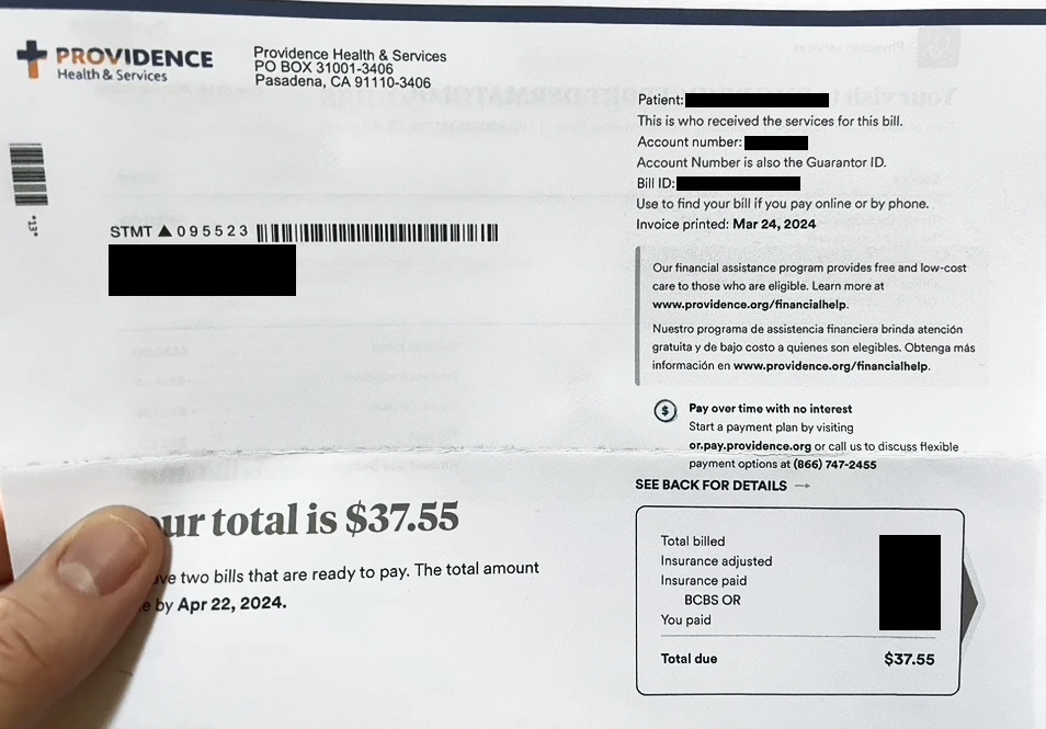 Photo of the paper bill with the patient, account, and bill IDs in the upper right corner. The total due is set in a large font in the middle of the paper.