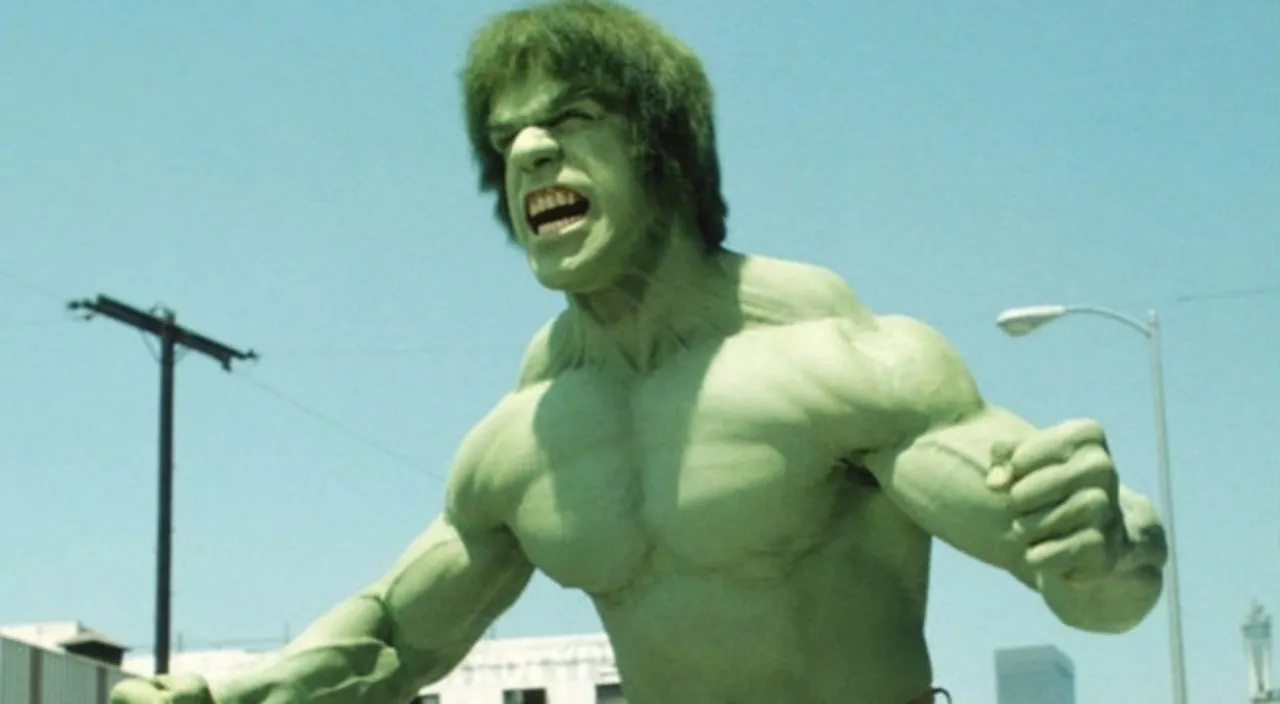 Lou Ferrigno as the Hulk from the 70s TV series with his arms raised while flexing his muscles and growling.