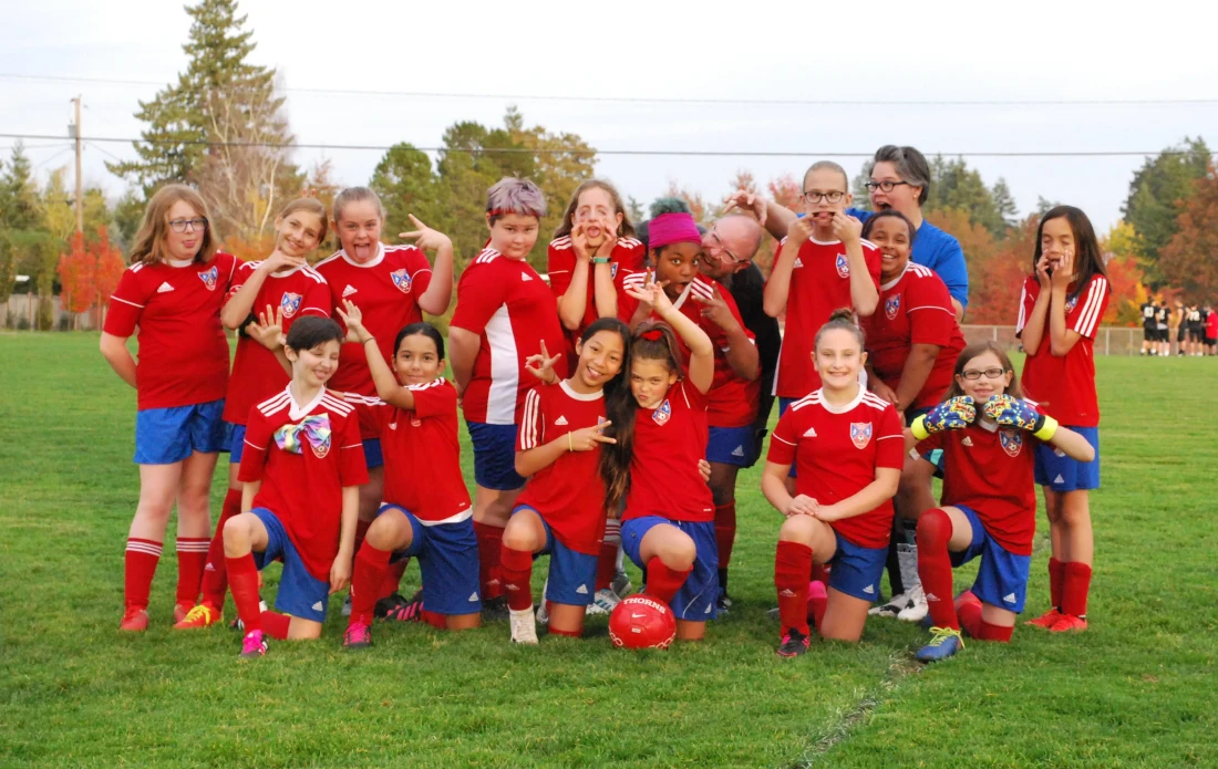 U-11 girls soccer team photo with everyone making silly faces.
